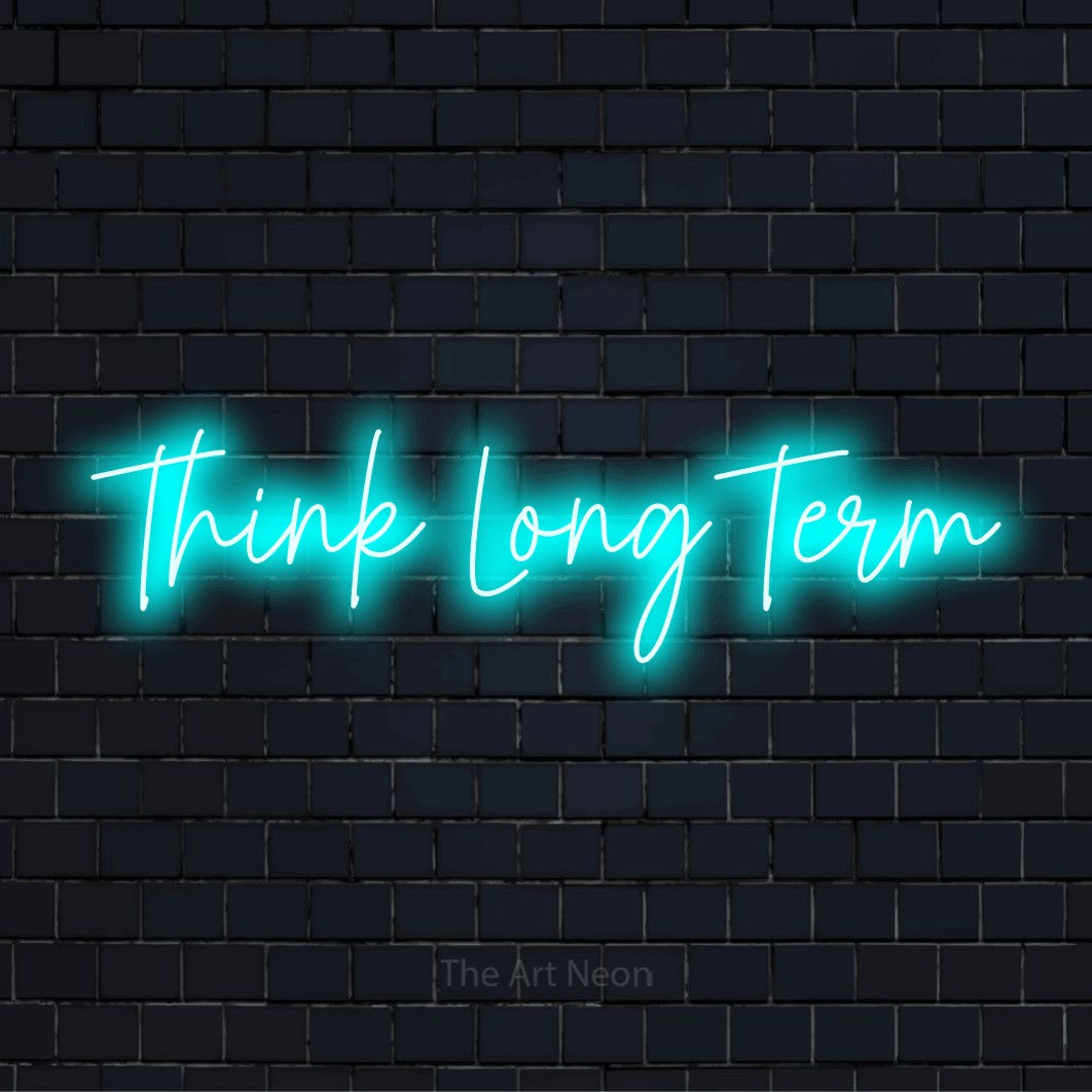 "Think Long Term" glowing LED neon sign on a black brick wall