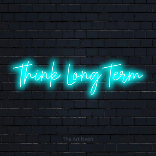 "Think Long Term" glowing LED neon sign on a black brick wall