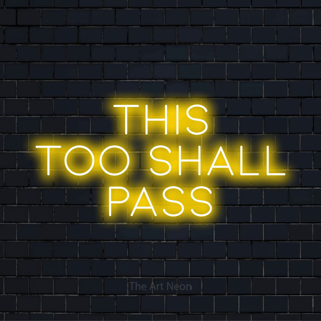 "This Too Shall Pass" LED neon sign on a black brick wall