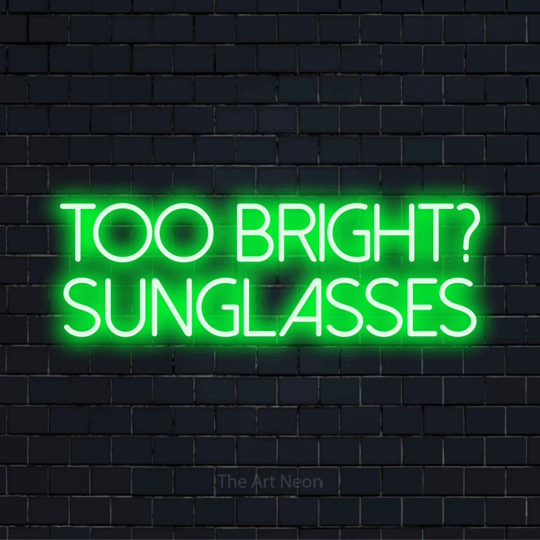 "Too Bright? Sunglasses" neon text design on a black brick wall