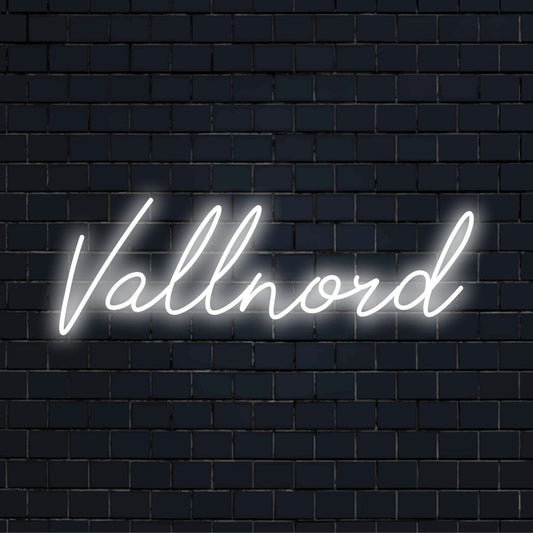 Vallnord Neon Sign, bright neon glow on dark brick wall