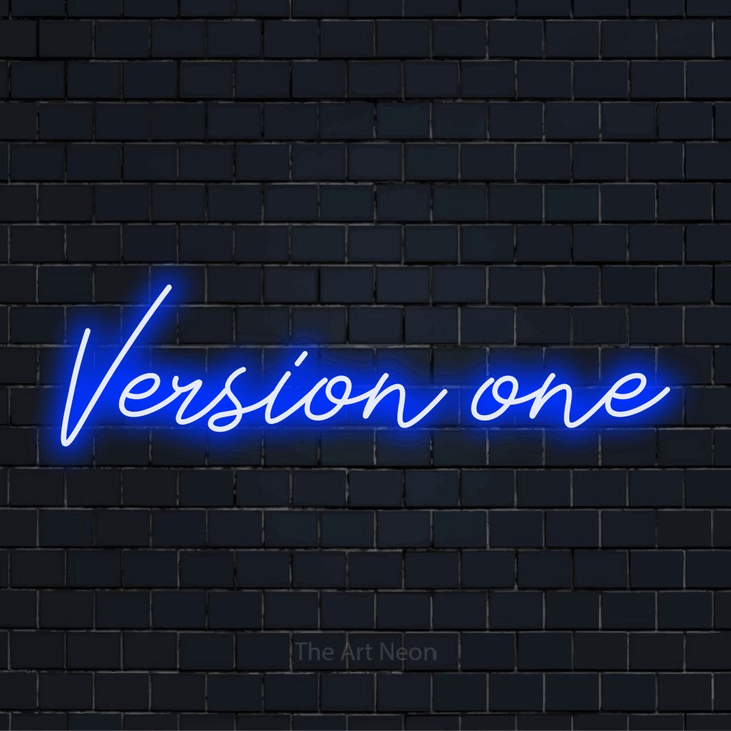 "Version One" script-style LED neon sign on a black brick wall
