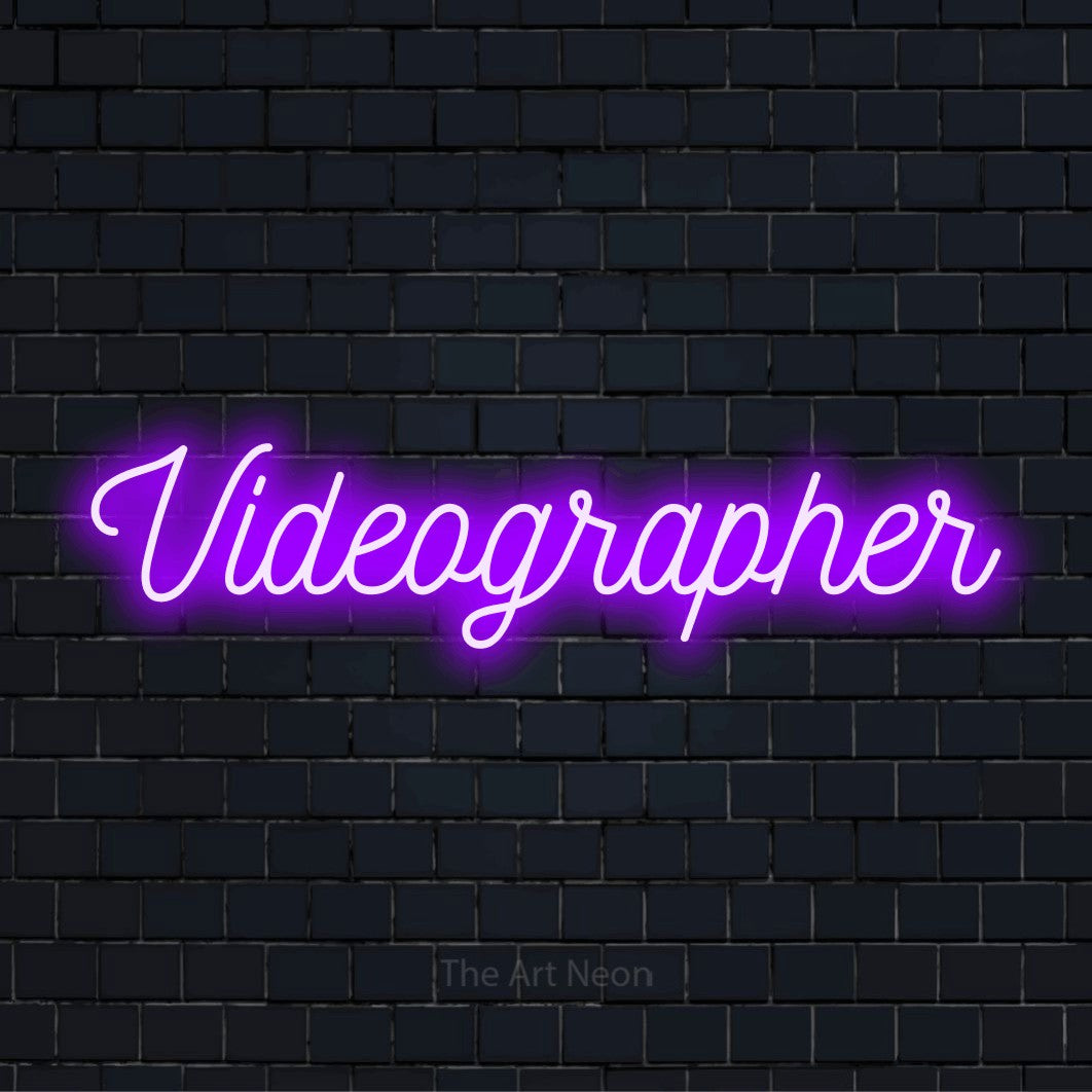 "Videographer" text design with neon effect on a black brick wall