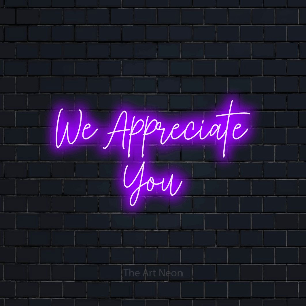"We Appreciate You" text design with neon effect on a black brick wall