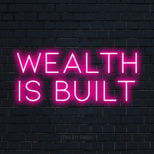 "Wealth Is Built" neon text design on a black brick wall