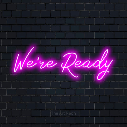 "We’re Ready" glowing LED neon sign on a black brick wall