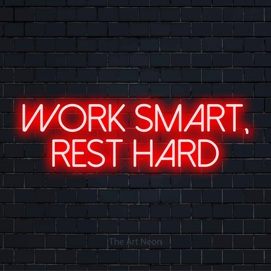 "Work Smart, Rest Hard" neon text design on a black brick wall