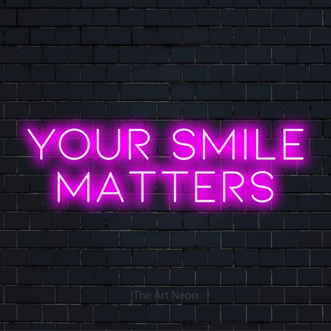 "Your Smile Matters" glowing LED neon sign on a black brick wall
