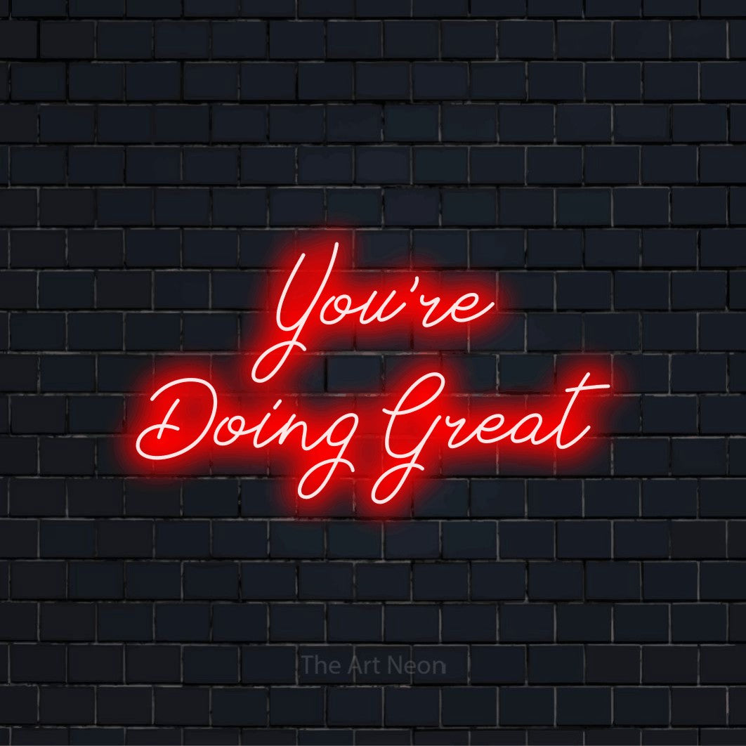 "You’re Doing Great" script-style LED neon sign on a black brick wall
